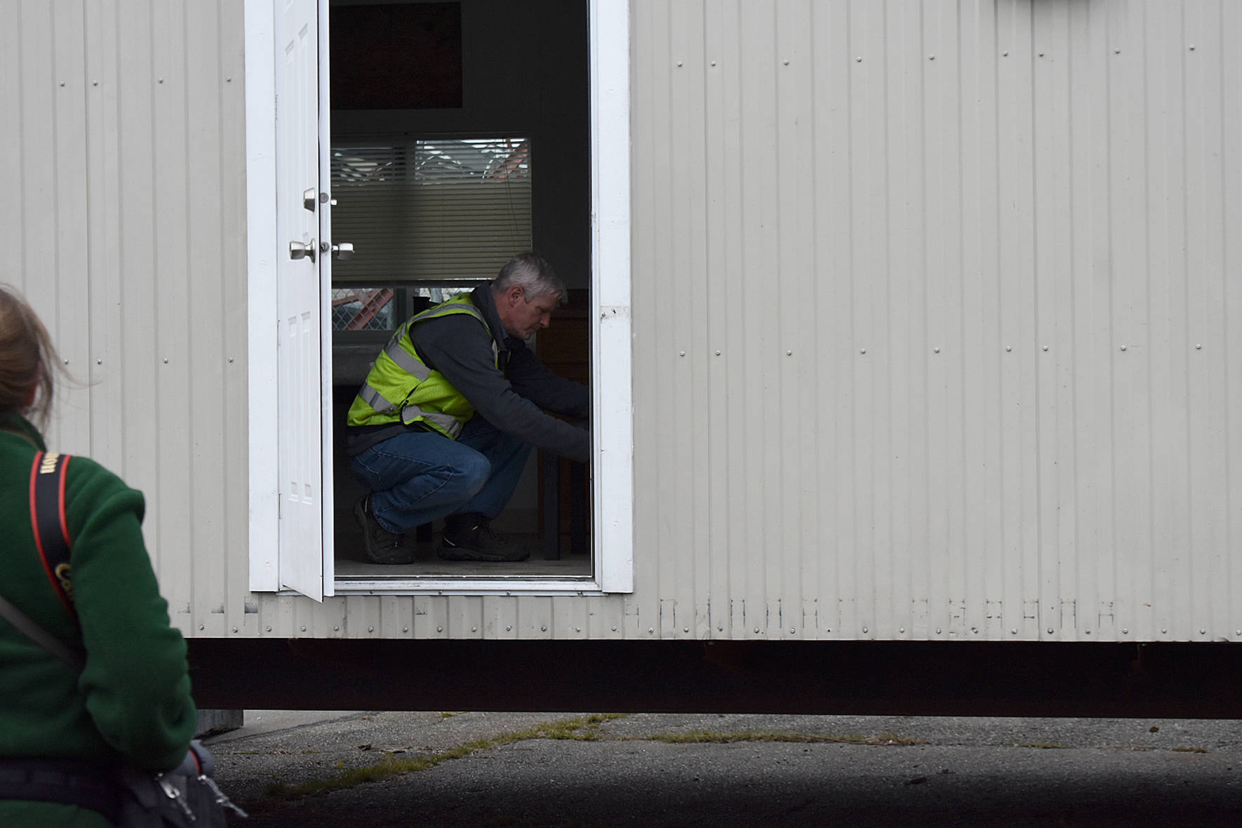 Photo by Haley Ausbun. An electrician inspects one of the four rooms in the first modular unit that will be ready for those under quarantine for COVID-19, coronavirus.