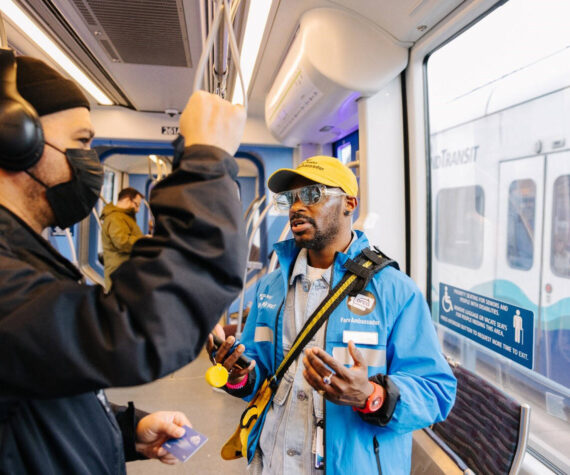 A Sound Transit fare ambassador checks with a light rail rider. COURTESY PHOTO, Sound Transit