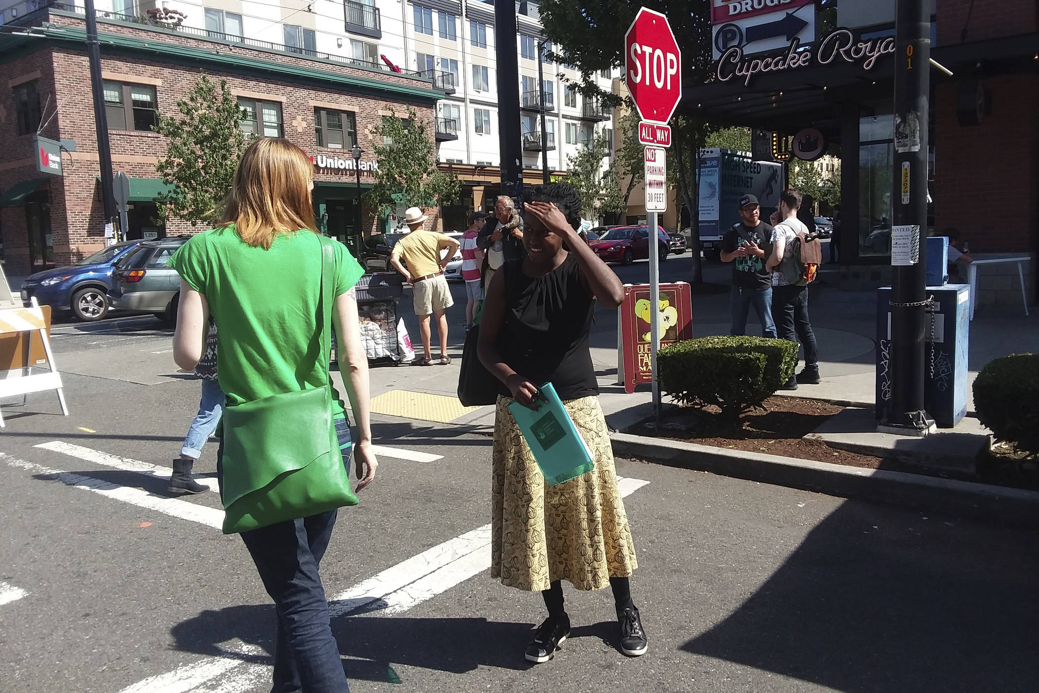 District 7 NACtivist Shaun Glaze petitions a farmers market shopper for her signature. Photo by Casey Jaywork