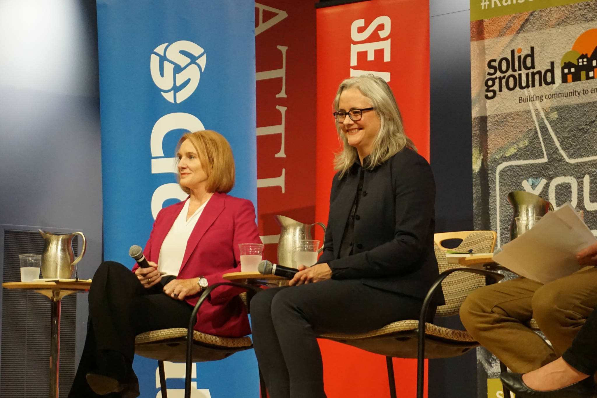 Jenny Durkan (left) and Cary Moon on stage inside Seattle University’s Pigott Auditorium at the Solid Ground debate on housing and homelessness on Tuesday, September 12, 2017. Photo by Casey Jaywork