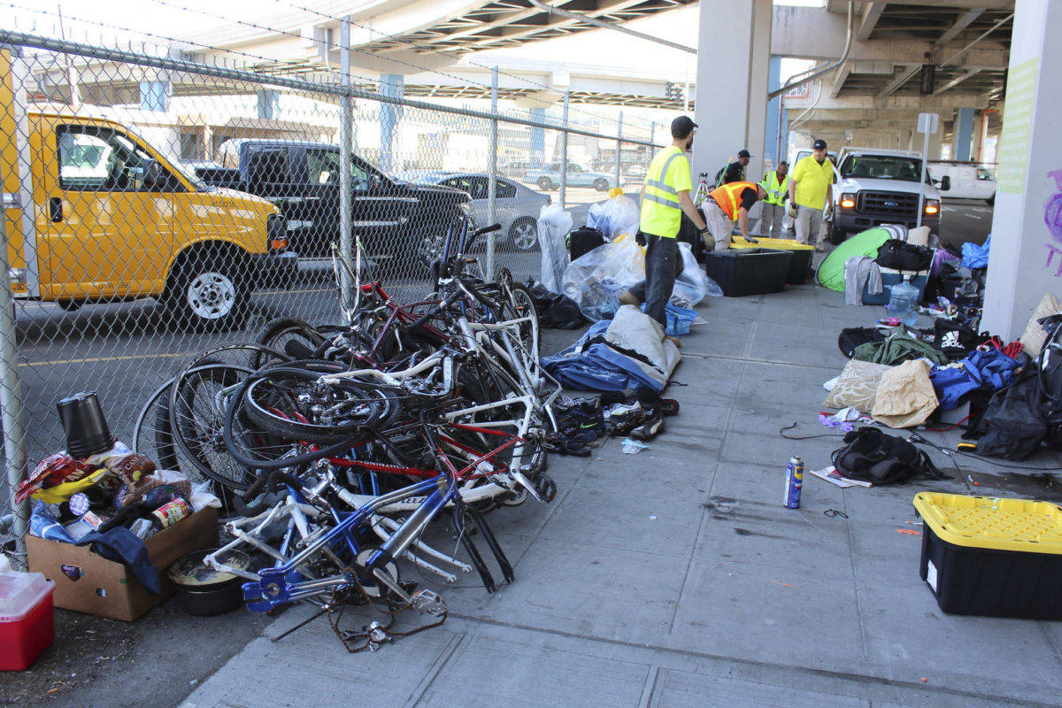 Possessions get cleared from the Spokane St. encampment. Photo by Sara Bernard